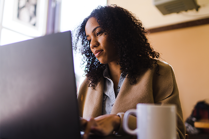 biracial woman works on computer